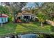 Single Gathering home with a lake view and lush landscaping at 3195 Village Ln, Port Charlotte, FL 33953