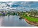 Aerial view of lakefront home near golf course at 3195 Village Ln, Port Charlotte, FL 33953