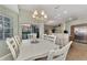 Spacious dining room with white table and access to the kitchen and patio at 3195 Village Ln, Port Charlotte, FL 33953