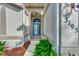 Inviting front entry with a charming blue door and arched entryway at 3195 Village Ln, Port Charlotte, FL 33953
