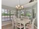 Bright dining room with white table and chairs, featuring a chandelier at 3195 Village Ln, Port Charlotte, FL 33953