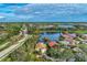 Aerial view of a house community with lake and golf course at 3195 Village Ln, Port Charlotte, FL 33953