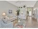 Comfortable living room featuring light colored sofas and a view to entry at 3195 Village Ln, Port Charlotte, FL 33953