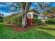 Landscaped backyard with lush greenery and mature trees at 3195 Village Ln, Port Charlotte, FL 33953