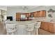 Updated kitchen with granite countertops, stainless steel appliances, and breakfast bar at 3195 Village Ln, Port Charlotte, FL 33953