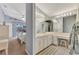 Double vanity bathroom with a large mirror and view to bedroom at 3195 Village Ln, Port Charlotte, FL 33953