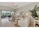 Open living room with a vaulted ceiling and sliding doors to patio at 3195 Village Ln, Port Charlotte, FL 33953