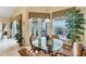 Kitchen nook with glass-top table and wicker chairs near sliding doors at 1033 Yosemite Dr, Englewood, FL 34223