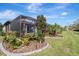 Landscaped backyard with tropical plants and a screened pool at 1337 Sorrell Way, North Port, FL 34289