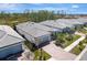 Aerial view of a house with gray roof and brick driveway at 1337 Sorrell Way, North Port, FL 34289