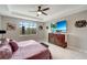 Main bedroom with king-size bed, large TV, and plenty of natural light at 1337 Sorrell Way, North Port, FL 34289