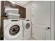 Laundry room with Whirlpool washer and dryer, and ample cabinet space at 1337 Sorrell Way, North Port, FL 34289