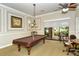 A well-lit game room with a pool table and comfortable seating at 1337 Sorrell Way, North Port, FL 34289