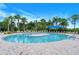 Circular pool with a central seating area and plenty of lounge chairs at 1337 Sorrell Way, North Port, FL 34289