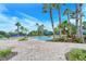 Community pool with ample lounge chairs and palm trees at 1337 Sorrell Way, North Port, FL 34289