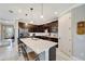 Updated kitchen featuring dark cabinetry, quartz countertops, and breakfast bar at 1337 Sorrell Way, North Port, FL 34289