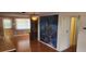Living room with hardwood floors and large ocean-themed mural at 1700 Morning Dove Ln, Englewood, FL 34224