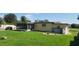 Spacious backyard with grassy lawn, screened patio, and storage shed at 1700 Morning Dove Ln, Englewood, FL 34224