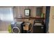 Bright laundry room, washer, dryer, sink, and shelf at 1700 Morning Dove Ln, Englewood, FL 34224