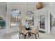 Breakfast nook with glass table and chairs near pool and lanai at 13400 Buckett Cir, Port Charlotte, FL 33981