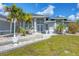 Front entrance of a gray house with double doors and palm trees at 13400 Buckett Cir, Port Charlotte, FL 33981