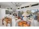 Spacious living room with white sofas, wooden accents, and access to the pool at 13400 Buckett Cir, Port Charlotte, FL 33981