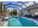 Inviting screened pool and patio area, perfect for relaxation and outdoor entertaining at 13400 Buckett Cir, Port Charlotte, FL 33981