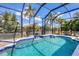 Refreshing screened pool with blue tile accents at 13400 Buckett Cir, Port Charlotte, FL 33981