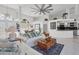Open concept living room with white sofas and a view into the kitchen at 13400 Buckett Cir, Port Charlotte, FL 33981