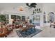 Gathering room with wicker furniture, tropical decor, and pool access at 13400 Buckett Cir, Port Charlotte, FL 33981