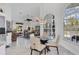 Bright breakfast nook with glass table and chairs, overlooking the pool at 13400 Buckett Cir, Port Charlotte, FL 33981