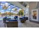Relaxing screened-in pool area with patio furniture at 13400 Buckett Cir, Port Charlotte, FL 33981
