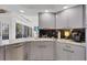 Modern kitchen with gray cabinets, granite countertops, and stainless steel appliances at 13400 Buckett Cir, Port Charlotte, FL 33981