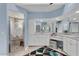 Bathroom featuring a shower with palm tree etching and double vanity at 13400 Buckett Cir, Port Charlotte, FL 33981