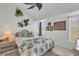 Bright bedroom with a king-size bed, nightstands, and tropical decor at 13400 Buckett Cir, Port Charlotte, FL 33981