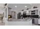 Modern kitchen with gray cabinets, marble countertops, and stainless steel appliances at 13400 Buckett Cir, Port Charlotte, FL 33981