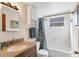 Clean bathroom with granite vanity, shower/tub combo, and a window at 25 1St Ave, Englewood, FL 34223