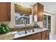 Kitchen features a double sink, granite countertops, and wood cabinets at 25 1St Ave, Englewood, FL 34223