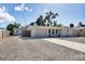 House exterior showcasing a gravel driveway and fenced backyard at 25 1St Ave, Englewood, FL 34223
