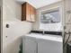 Laundry room with washer, dryer, and overhead cabinets at 25 1St Ave, Englewood, FL 34223