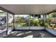 Screened porch with view of backyard and trees at 25 1St Ave, Englewood, FL 34223