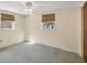 Well-lit bedroom with window, ceiling fan, and carpeting at 25 1St Ave, Englewood, FL 34223