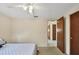 Bedroom with ceiling fan, door to hallway and window at 25 1St Ave, Englewood, FL 34223