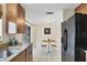 Kitchen boasting granite countertops, wood cabinets, and a double sink at 25 1St Ave, Englewood, FL 34223