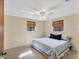 Spacious primary bedroom with a ceiling fan and carpeted flooring at 25 1St Ave, Englewood, FL 34223