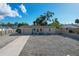 Single story home with gravel driveway and fenced yard at 25 1St Ave, Englewood, FL 34223