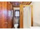 Bathroom with shower and wood-paneled walls at 25 1St Ave, Englewood, FL 34223