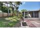 Backyard view showcasing a patio, screened porch, and lush lawn at 25 1St Ave, Englewood, FL 34223