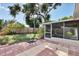 Spacious backyard with patio, screened enclosure, and mature trees at 25 1St Ave, Englewood, FL 34223