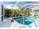 Refreshing swimming pool with screened enclosure and patio at 7171 Teaberry St, Englewood, FL 34224